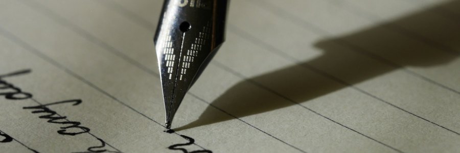 Fountain pen writing on black-lined paper.