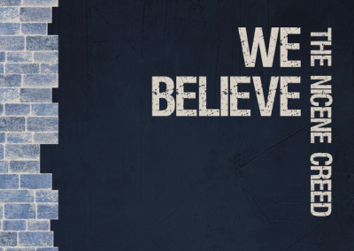 Image is a pale blue and cream column of part of a brick wall on a dark blue background. Horizontal text reads 'We believe', vertical text reads 'The Nicene Creed'.